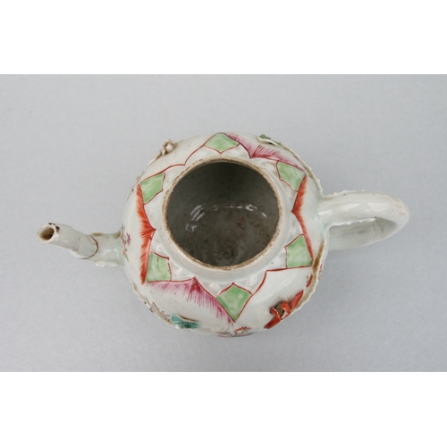 761 - A Chinese famille teapot decorated with flowers and applied scrolling flowers and foliage, 12cms hig... 