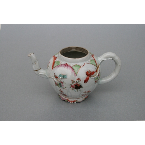 761 - A Chinese famille teapot decorated with flowers and applied scrolling flowers and foliage, 12cms hig... 