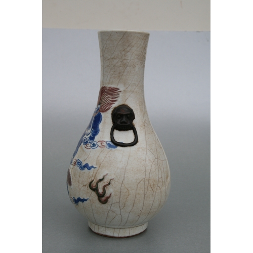 732 - A Chinese crackleware two-handled baluster vase decorated with shi shi, 26cms high.Condition Reportg... 