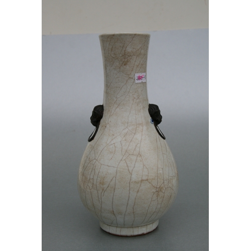 732 - A Chinese crackleware two-handled baluster vase decorated with shi shi, 26cms high.Condition Reportg... 