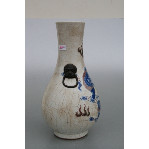 732 - A Chinese crackleware two-handled baluster vase decorated with shi shi, 26cms high.Condition Reportg... 