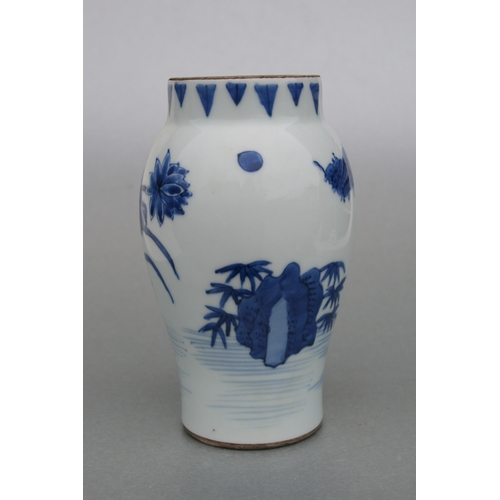 829 - A Chinese blue & white tankard decorated with a river landscape scene with dragon handle, 14cms high... 