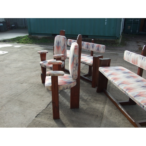 923 - A Maori influenced dining room suite made from a New Zealand hardwood, comprising two benches, two m... 