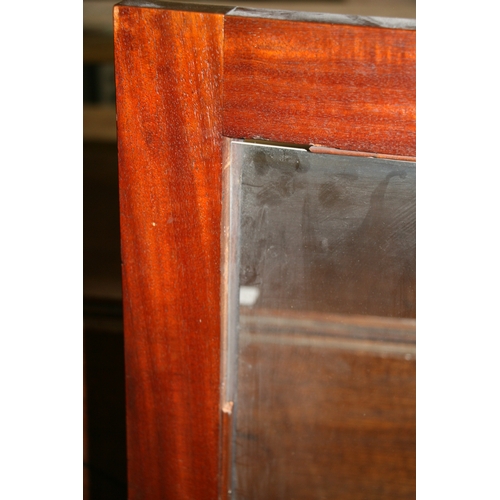 991 - A late Regency mahogany breakfront bookcase in the manner of Gillows, with a pair of central glazed ... 