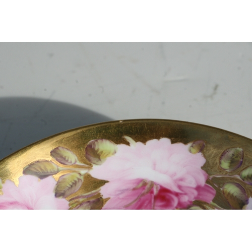 134 - An early 19th century Coalport cup and saucer, finely painted with a large band of pink roses and bu... 