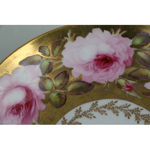 134 - An early 19th century Coalport cup and saucer, finely painted with a large band of pink roses and bu... 