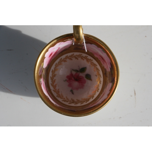 134 - An early 19th century Coalport cup and saucer, finely painted with a large band of pink roses and bu... 