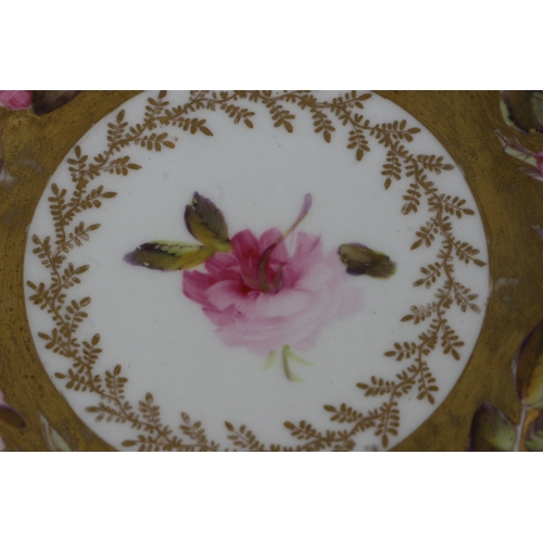 134 - An early 19th century Coalport cup and saucer, finely painted with a large band of pink roses and bu... 