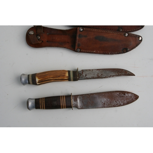 38 - Two German sheath knives in leather scabbards, 21cms long; together with a carved wooden box contain... 