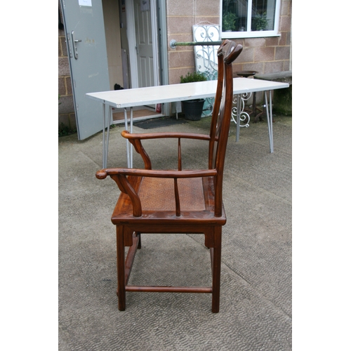 850 - A Chinese hardwood 'Official's Hat' chair with rattan seat.