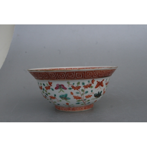 853 - A Chinese famille rose bowl decorated with flowers and butterflies, red seal mark to the underside, ... 