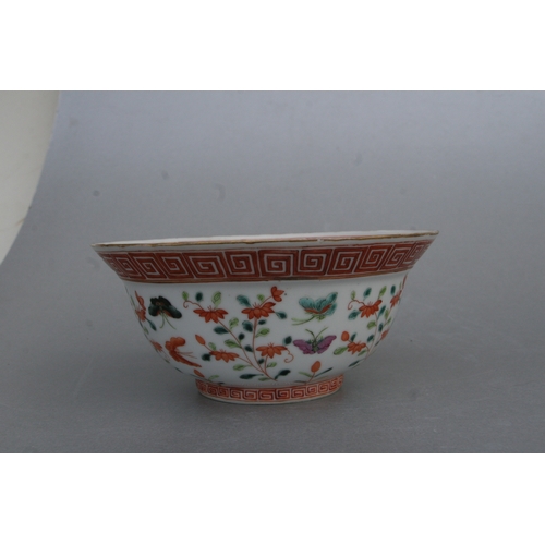 853 - A Chinese famille rose bowl decorated with flowers and butterflies, red seal mark to the underside, ... 