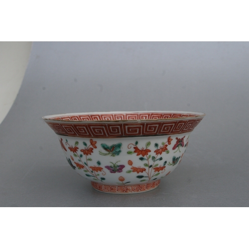 853 - A Chinese famille rose bowl decorated with flowers and butterflies, red seal mark to the underside, ... 