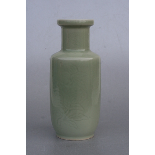 851 - A Chinese celadon glaze vase decorated with foliage and fruit, 24cms high (drilled).