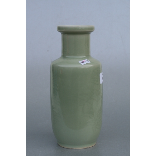 851 - A Chinese celadon glaze vase decorated with foliage and fruit, 24cms high (drilled).