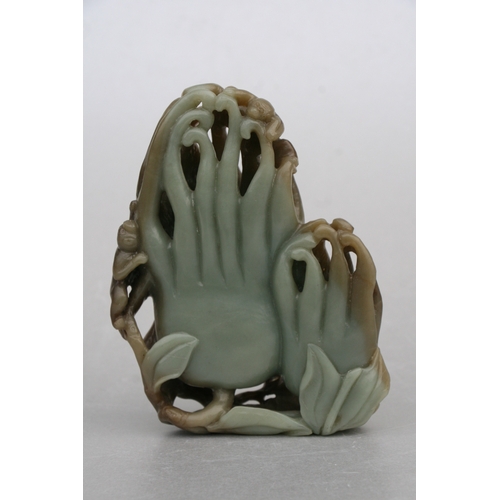 831 - A Chinese carved greenstone fruit 'Buddha's hand', 17cms high, mounted on a hardwood stand; together... 