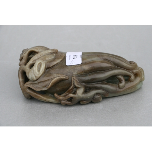 831 - A Chinese carved greenstone fruit 'Buddha's hand', 17cms high, mounted on a hardwood stand; together... 