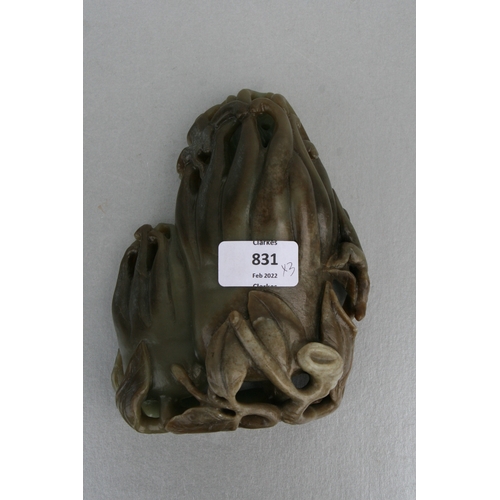 831 - A Chinese carved greenstone fruit 'Buddha's hand', 17cms high, mounted on a hardwood stand; together... 