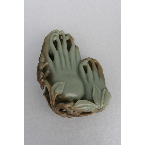 831 - A Chinese carved greenstone fruit 'Buddha's hand', 17cms high, mounted on a hardwood stand; together... 