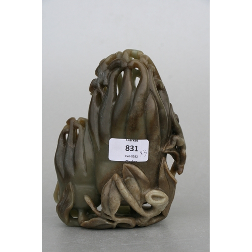 831 - A Chinese carved greenstone fruit 'Buddha's hand', 17cms high, mounted on a hardwood stand; together... 