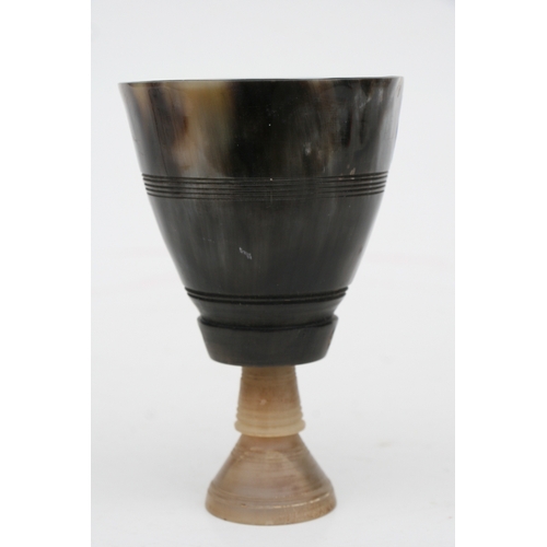 476 - A buffalo horn goblet with rhino horn stem, 14cms high.