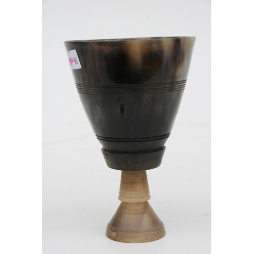 476 - A buffalo horn goblet with rhino horn stem, 14cms high.