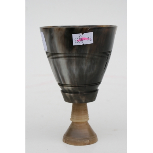 476 - A buffalo horn goblet with rhino horn stem, 14cms high.