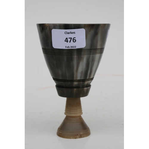 476 - A buffalo horn goblet with rhino horn stem, 14cms high.