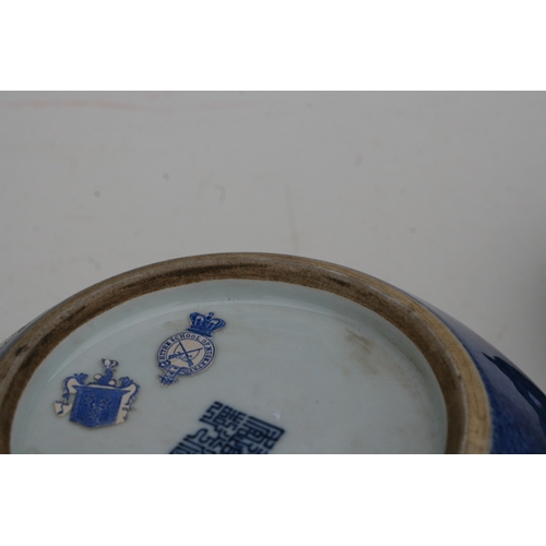 834 - A Chinese fish bowl of small proportions decorated with figures beside a pond, on a blue ground with... 