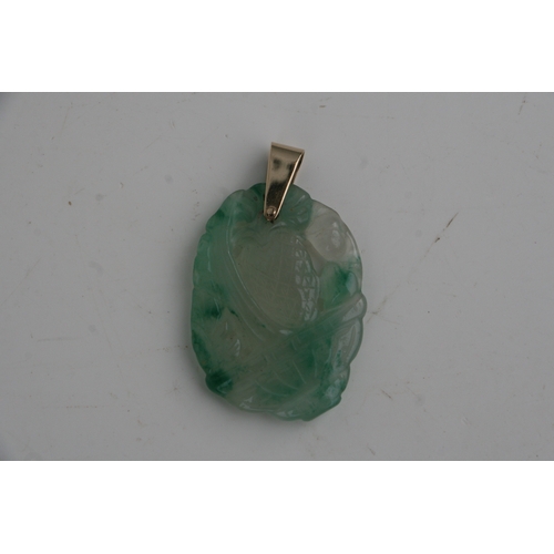 665 - A Chinese pierced hardstone pendant with yellow metal bale, 5cms high.