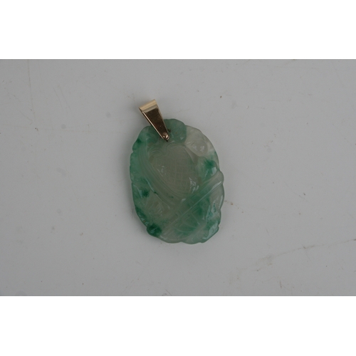 665 - A Chinese pierced hardstone pendant with yellow metal bale, 5cms high.