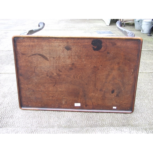 950 - A George III mahogany silver table with dished rectangular top above a shaped apron, on shell capped... 