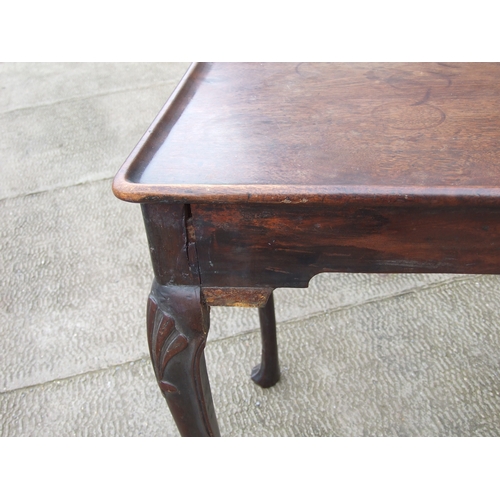 950 - A George III mahogany silver table with dished rectangular top above a shaped apron, on shell capped... 