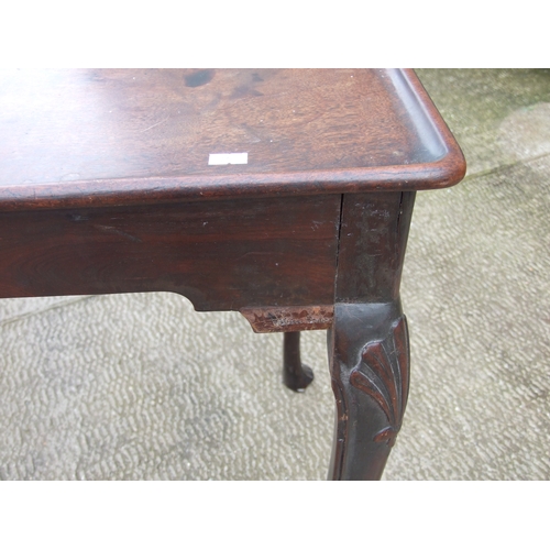 950 - A George III mahogany silver table with dished rectangular top above a shaped apron, on shell capped... 