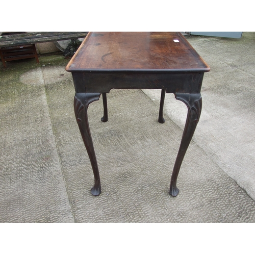 950 - A George III mahogany silver table with dished rectangular top above a shaped apron, on shell capped... 