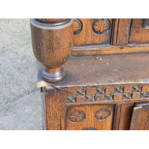 1019 - A 17th century style carved oak court cupboard of small proportions, 70cms wide.