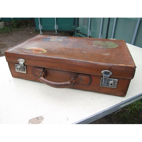 554 - Five vintage leather suitcases, the largest 70cms (5).