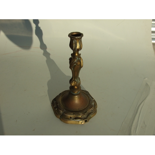 411 - A pair of bronze Rococo style candlesticks, 24cms high.