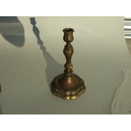 411 - A pair of bronze Rococo style candlesticks, 24cms high.