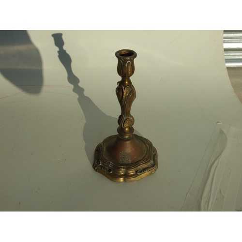 411 - A pair of bronze Rococo style candlesticks, 24cms high.