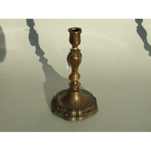 411 - A pair of bronze Rococo style candlesticks, 24cms high.