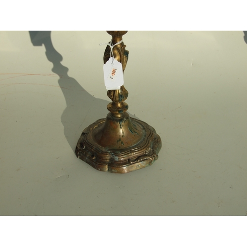 411 - A pair of bronze Rococo style candlesticks, 24cms high.