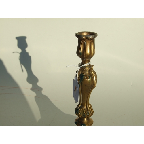 411 - A pair of bronze Rococo style candlesticks, 24cms high.