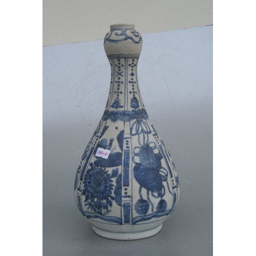 784 - A Chinese blue & white baluster vase decorated with flowers and precious objects, 29cms high.