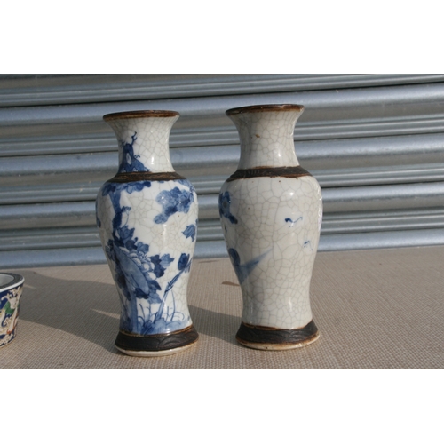 843 - A pair of Chinese blue & white crackle ware vases decorated with flowers, incised mark to the unders... 