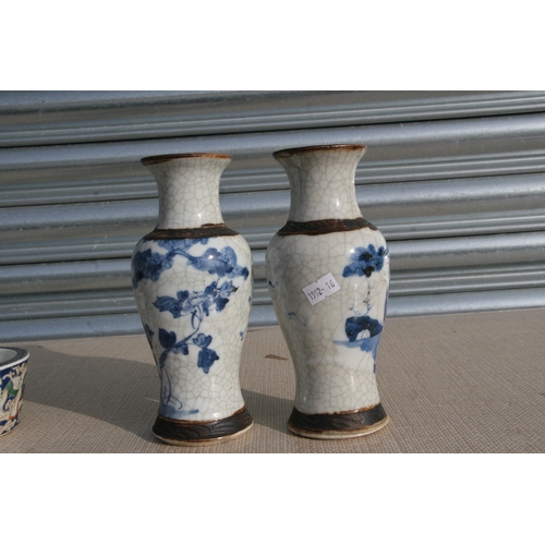 843 - A pair of Chinese blue & white crackle ware vases decorated with flowers, incised mark to the unders... 