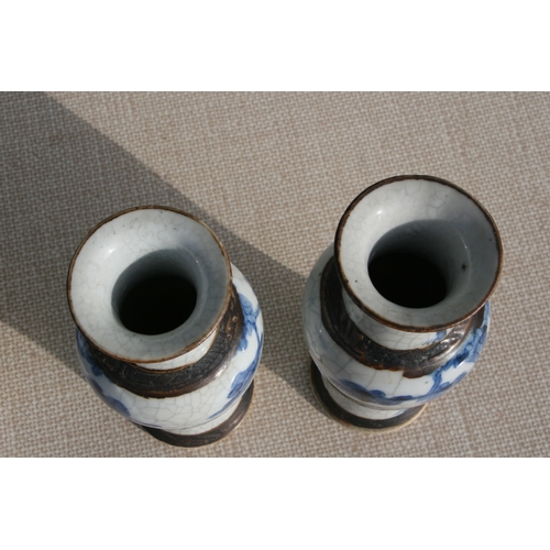 843 - A pair of Chinese blue & white crackle ware vases decorated with flowers, incised mark to the unders... 