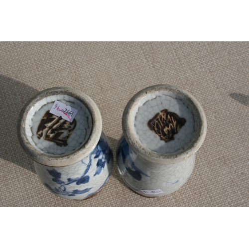 843 - A pair of Chinese blue & white crackle ware vases decorated with flowers, incised mark to the unders... 