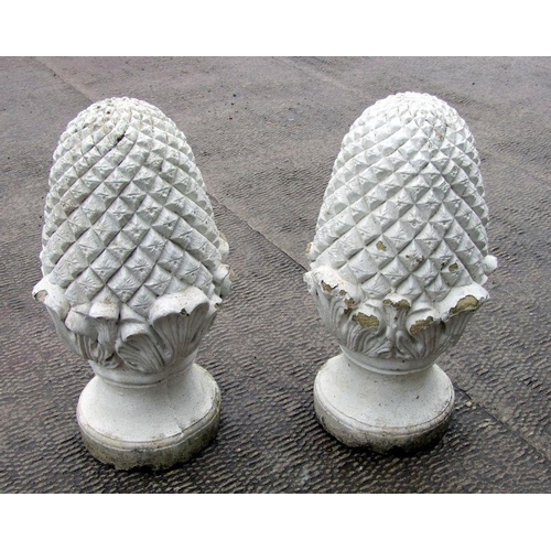 10 - A pair of well weathered painted reconstituted stone pineapple finials, 60cms high (2).