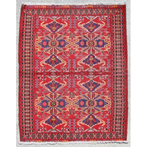 102 - A Persian hand knotted Gonbad rug with butterfly design within stylised borders, on a red ground, 18... 